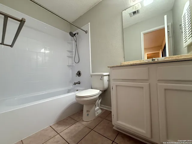a bathroom with a toilet sink and shower