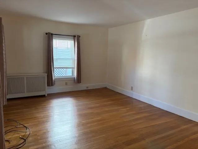 a kitchen with stainless steel appliances granite countertop a stove a refrigerator a sink a microwave oven with a dining table and chairs with wooden floor