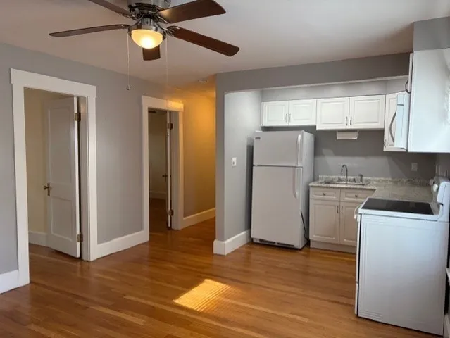 a kitchen with a sink a stove and cabinets