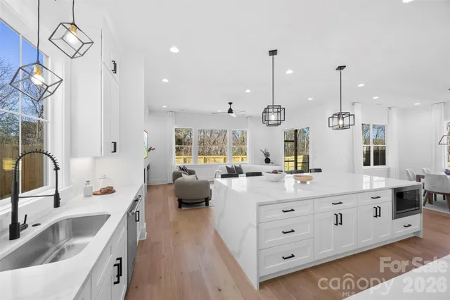a large kitchen with stainless steel appliances kitchen island a large island in the center