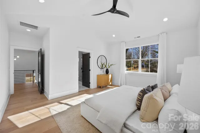 a bedroom with a large bed and a window