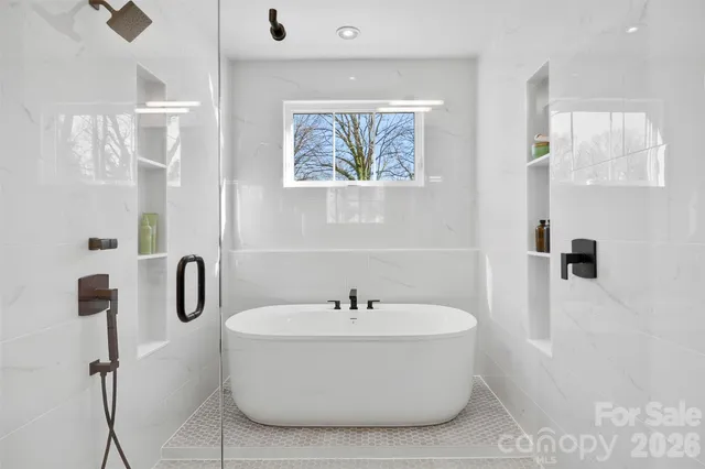 a white bath tub sitting next to a bathroom