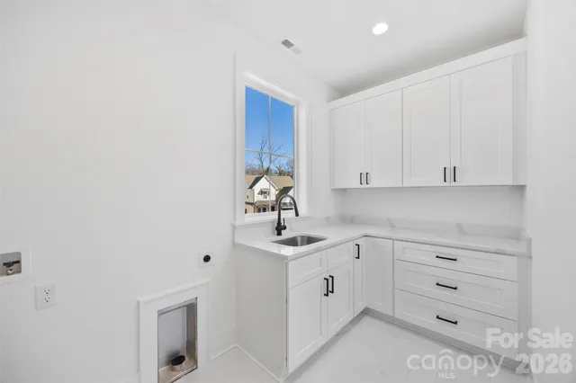 an empty room with wooden floor ceiling fan and windows