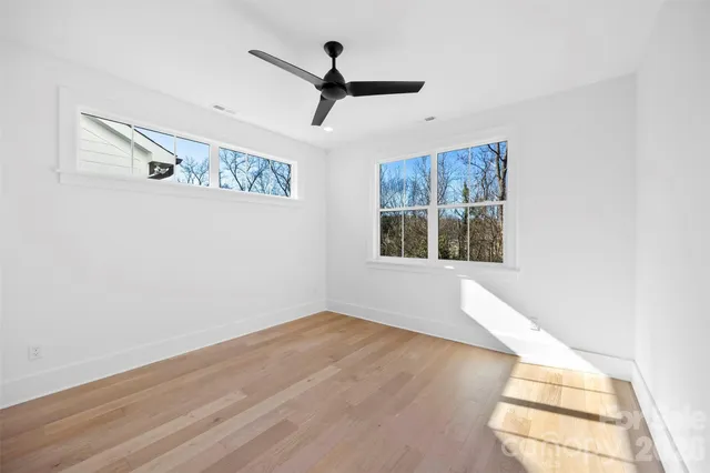 a view of empty room with ceiling fan