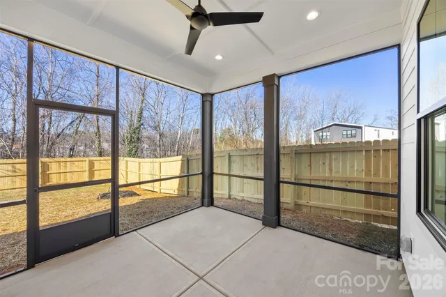 an empty room with windows and closet