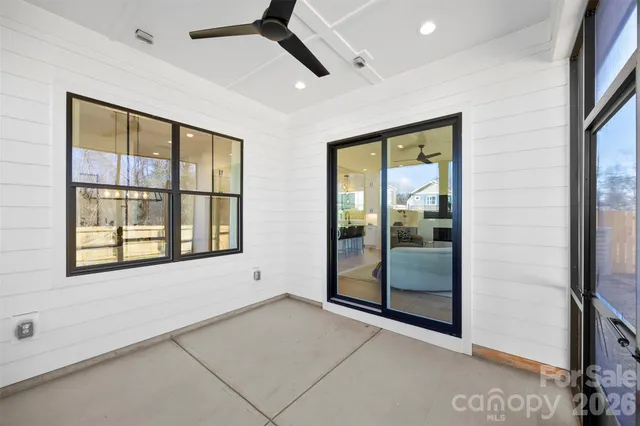a view of backyard with outdoor seating and green space