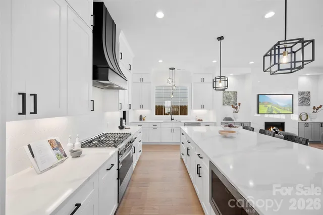 a large white kitchen with a stove and a sink