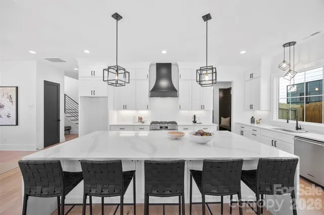 a dining room filled chandelier and wooden floor