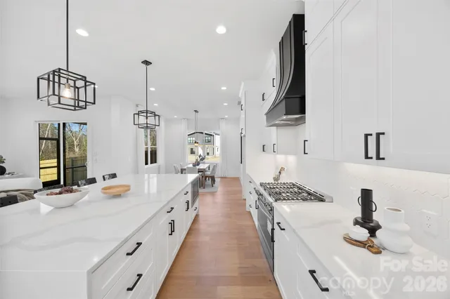 a kitchen with sink stove and cabinets
