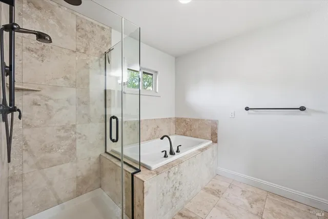 a bathroom with a bathtub and shower