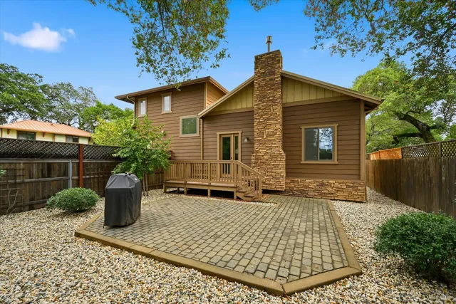 a backyard of a house with potted plants