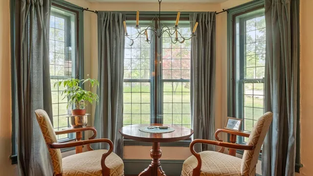 a view of a dining room with furniture and a window