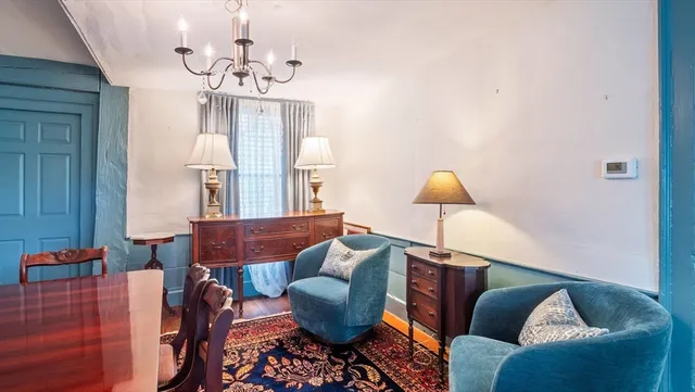 a living room with furniture and a chandelier
