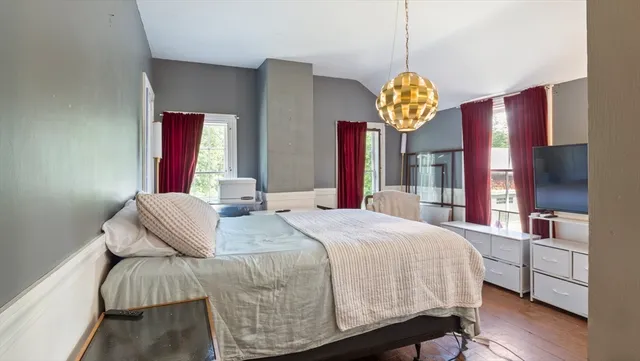 a bedroom with a bed and a chandelier