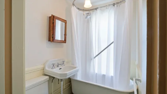 a bathroom with a sink a mirror and a window