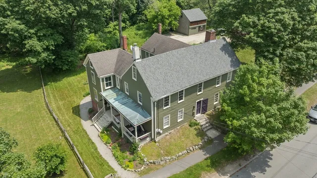 a aerial view of a house with swimming pool next to a yard