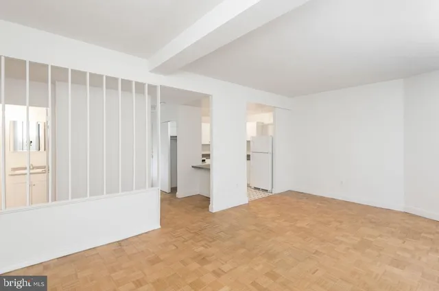 an empty room with windows and closet