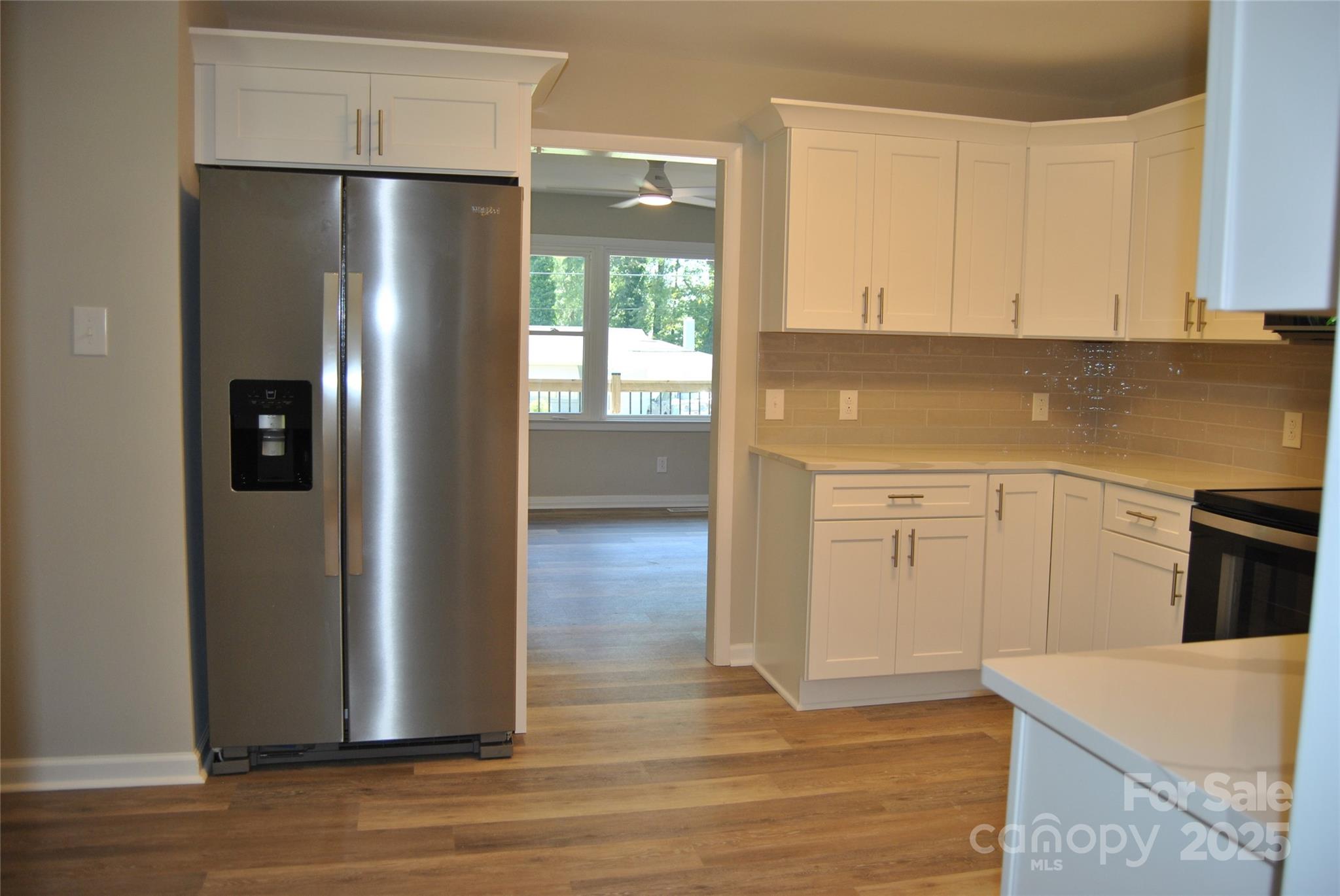 1737 Findlay Street Gastonia, NC 28052 - Photo 13 of 35 a kitchen with stainless steel appliances granite countertop a refrigerator a stove and a sink with wooden floor