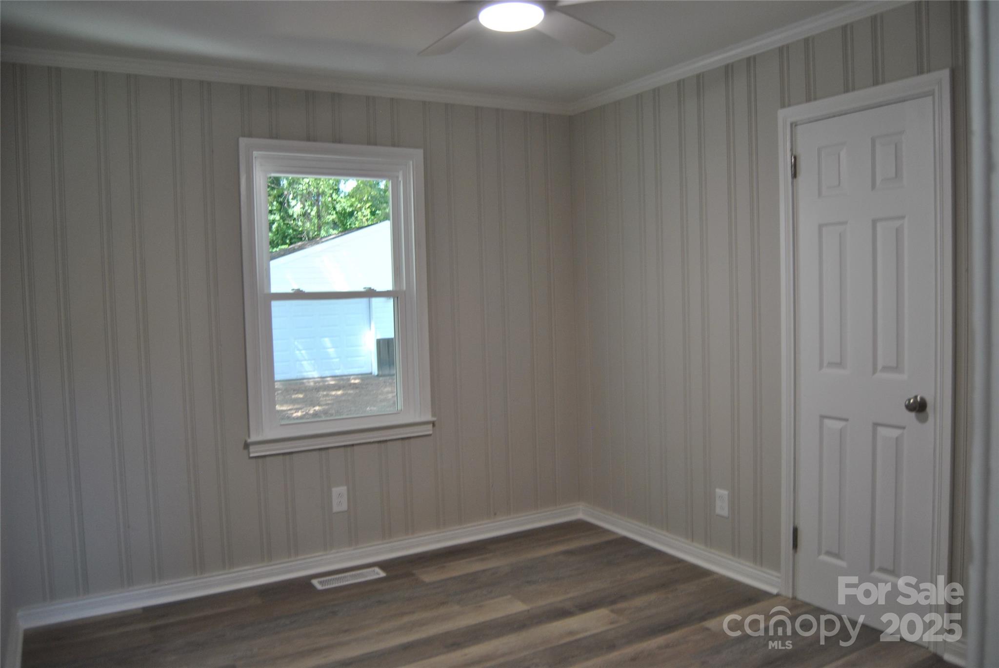1737 Findlay Street Gastonia, NC 28052 - Photo 23 of 35 a view of an empty room with wooden floor and a window