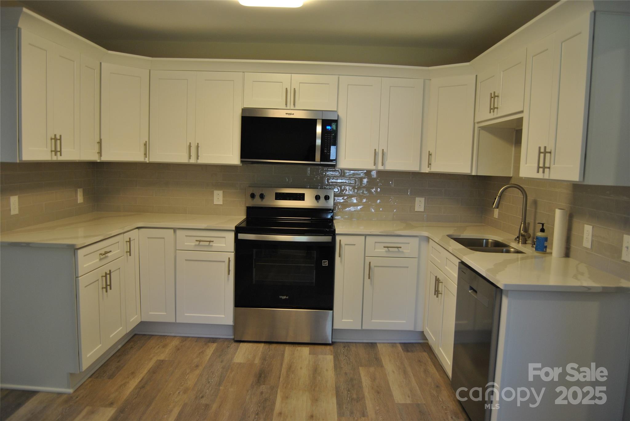 1737 Findlay Street Gastonia, NC 28052 - Photo 9 of 35 a kitchen with white cabinets sink and stainless steel appliances