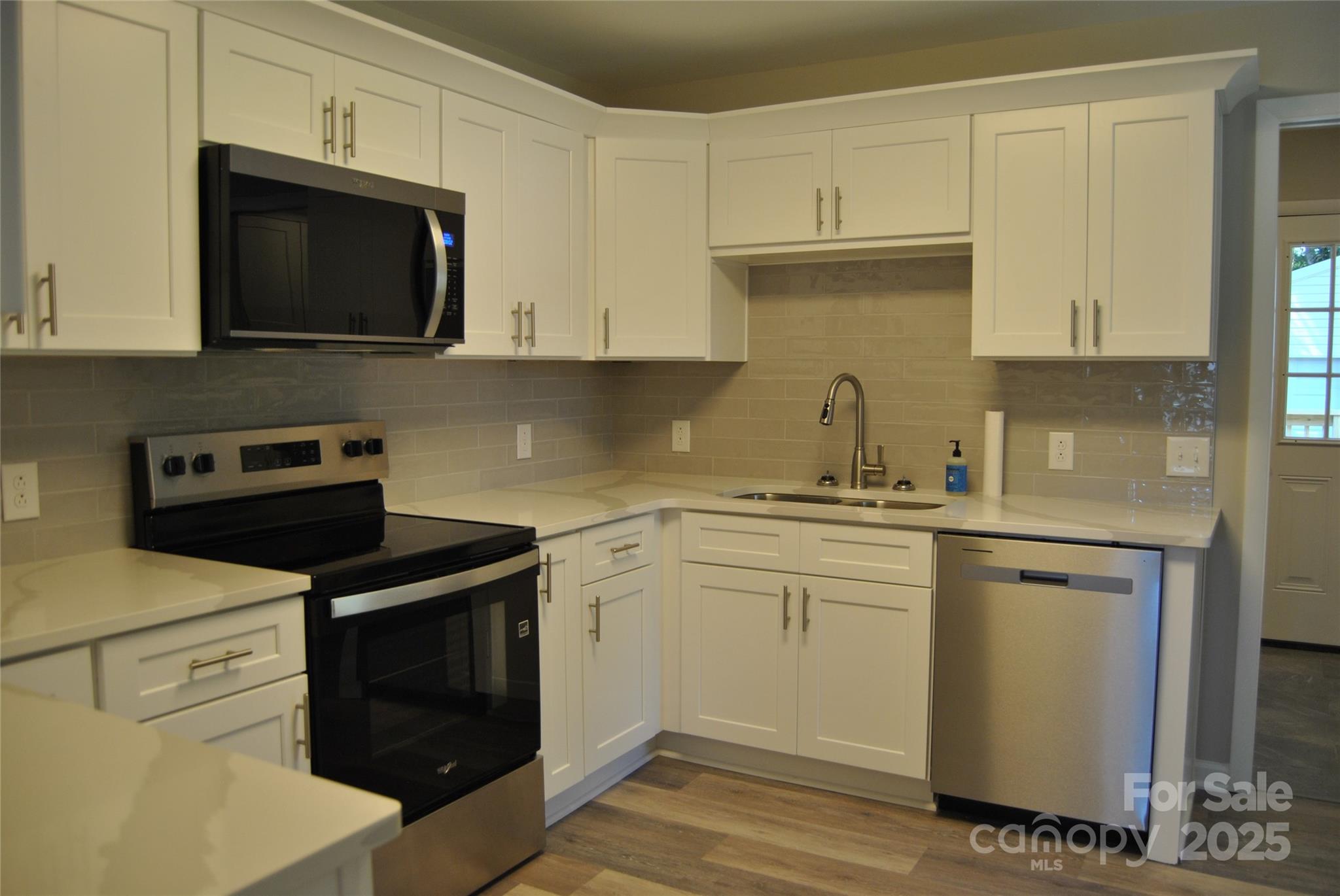 1737 Findlay Street Gastonia, NC 28052 - Photo 10 of 35 a kitchen with stainless steel appliances granite countertop a sink a stove a microwave and cabinets
