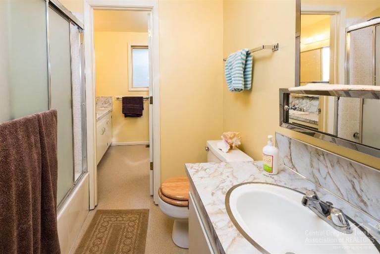 61839 Dobbin Road Bend, OR 97702 - Photo 11 of 23 a en suite bathroom with a granite countertop sink and a mirror