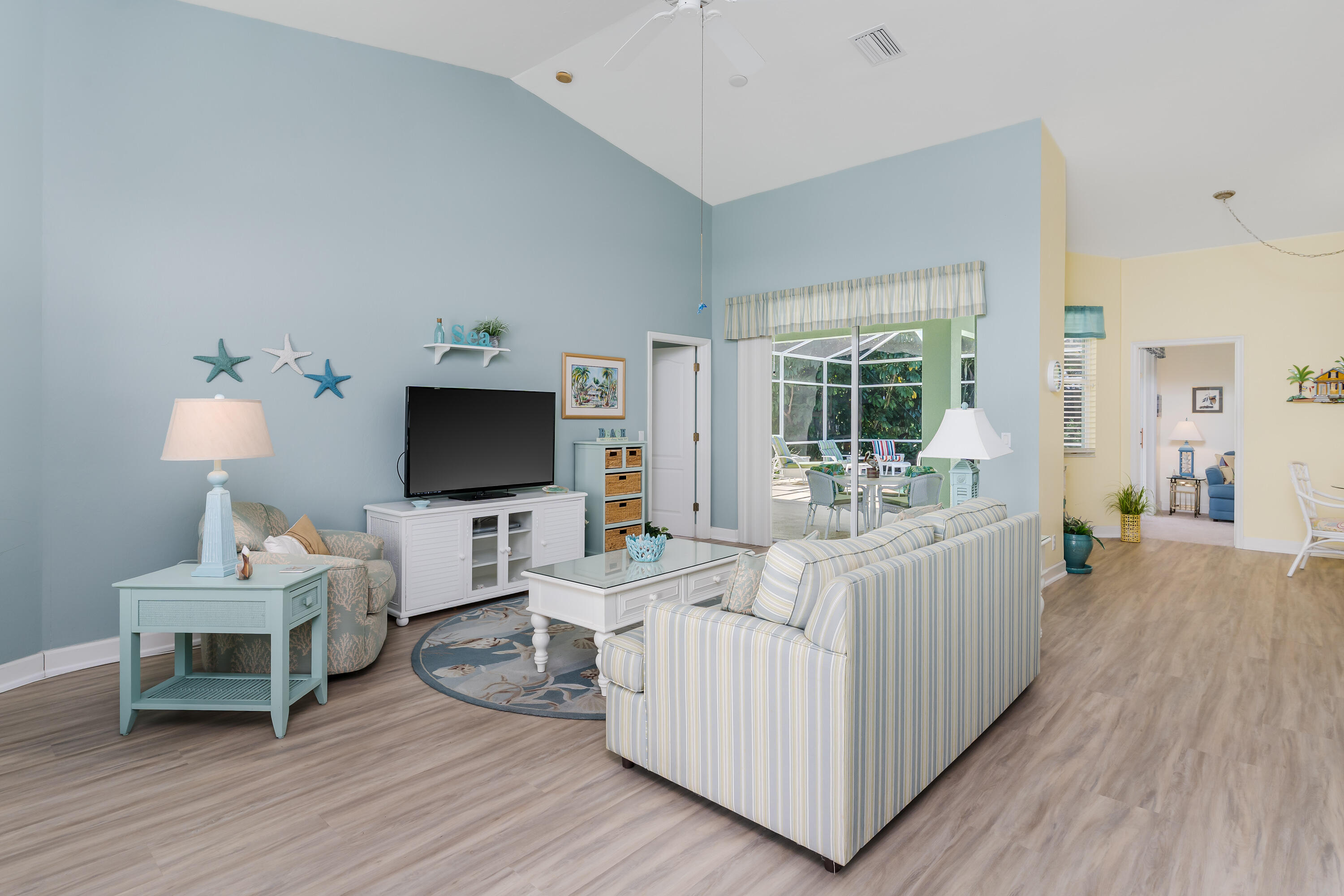 951 Java Court Marco Island, FL 34145 - Photo 12 of 55 a living room with furniture a flat screen tv and a wooden floor