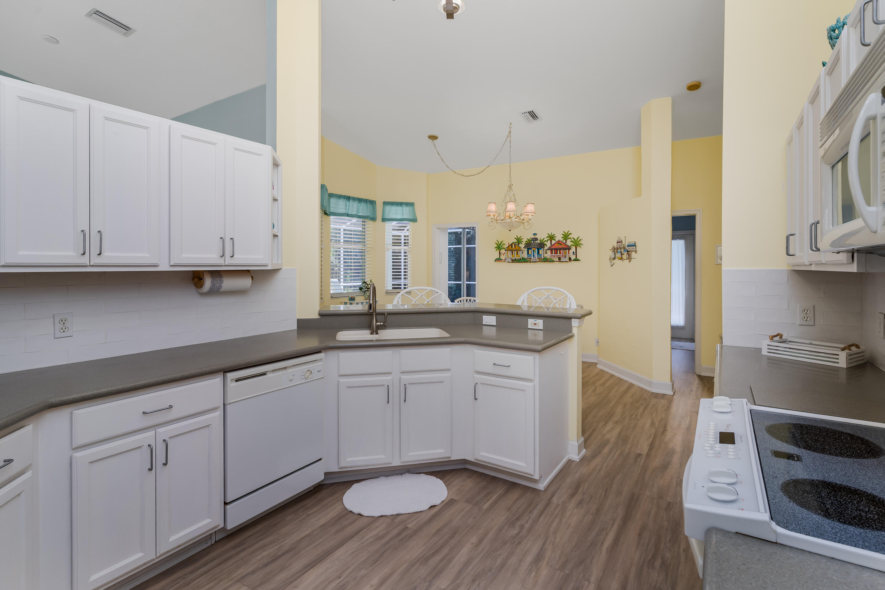 951 Java Court Marco Island, FL 34145 - Photo 20 of 55 a kitchen with sink cabinets and wooden floor