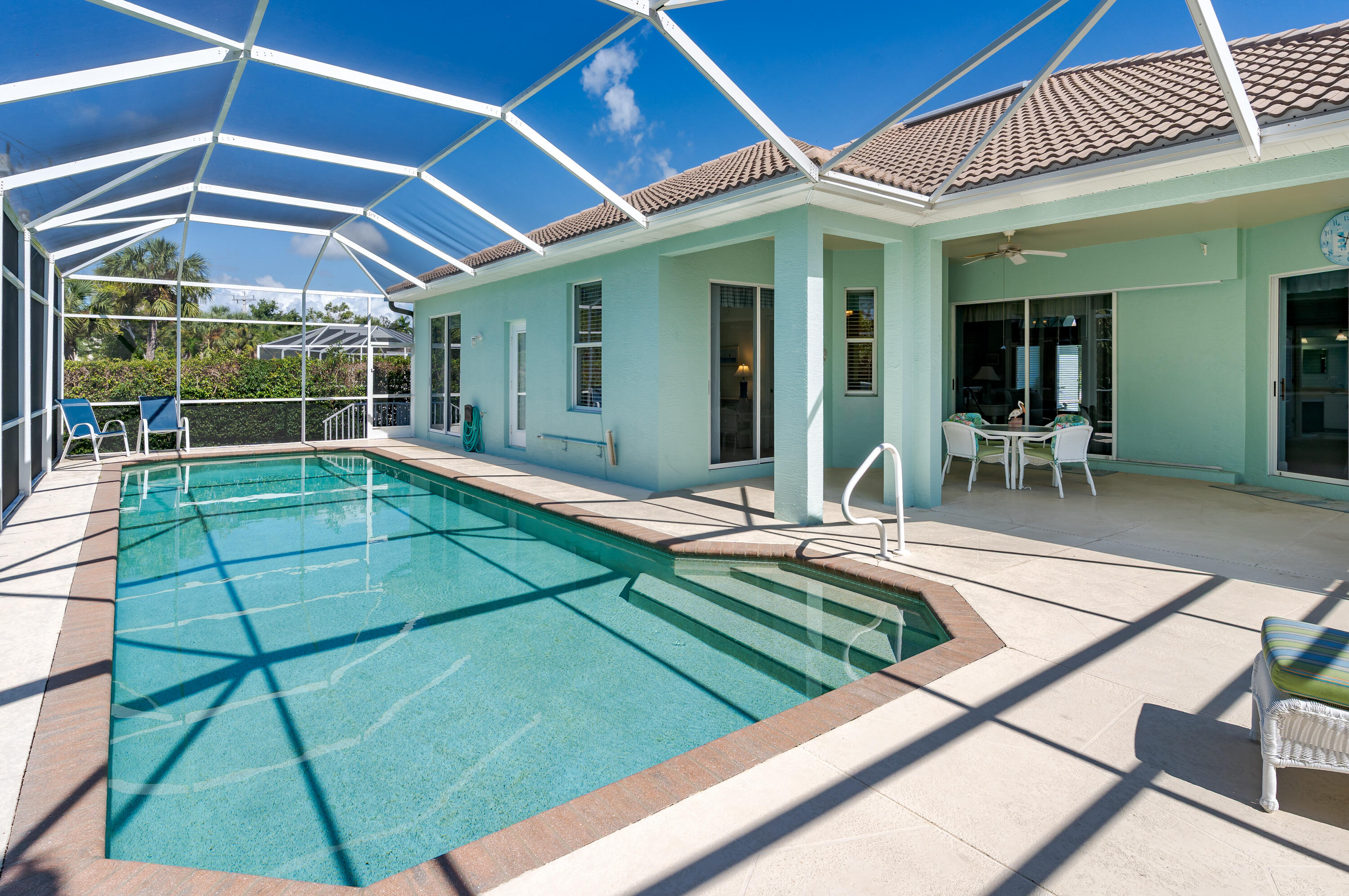 951 Java Court Marco Island, FL 34145 - Photo 7 of 55 a view of a backyard patio with table and chairs under an umbrella