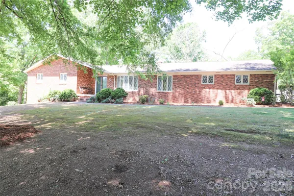 a view of a house with yard and a garden