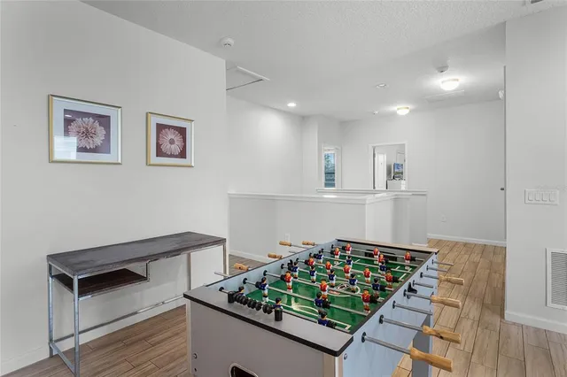 a bathroom with a granite countertop sink a toilet a mirror and shower
