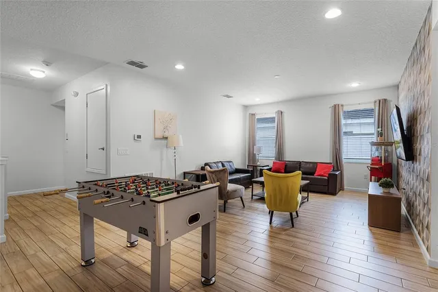 a white bath tub sitting next to a white toilet and a shower
