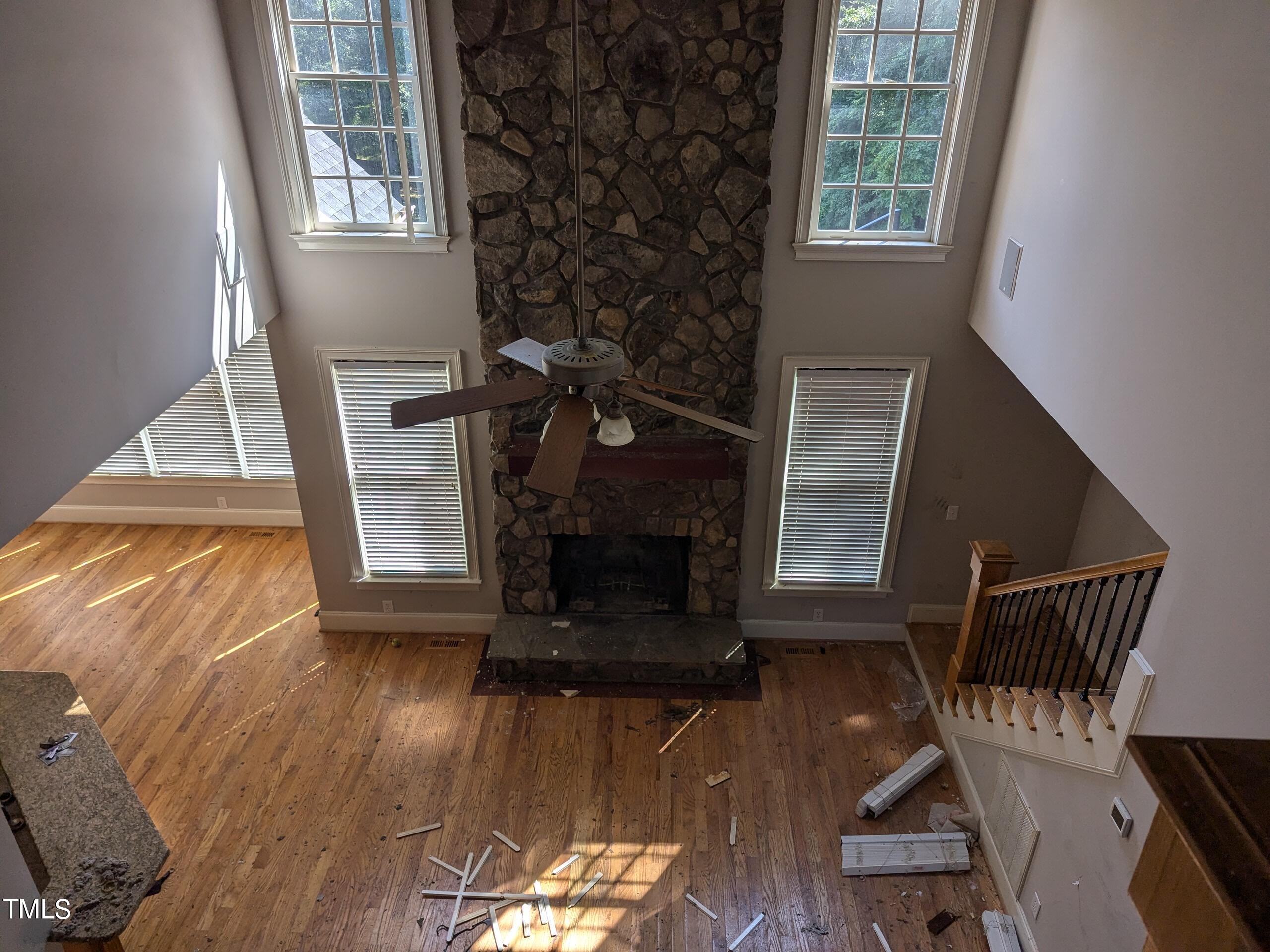 151 Michael Way Clayton, NC 27520 - Photo 25 of 36 an empty room with wooden floor a fireplace and windows