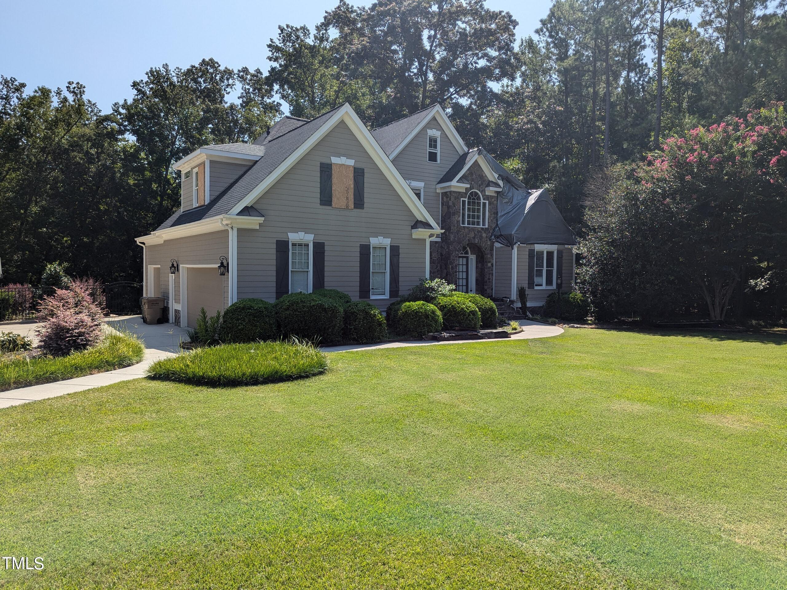 151 Michael Way Clayton, NC 27520 - Photo 36 of 36 a front view of a house with a garden and plants