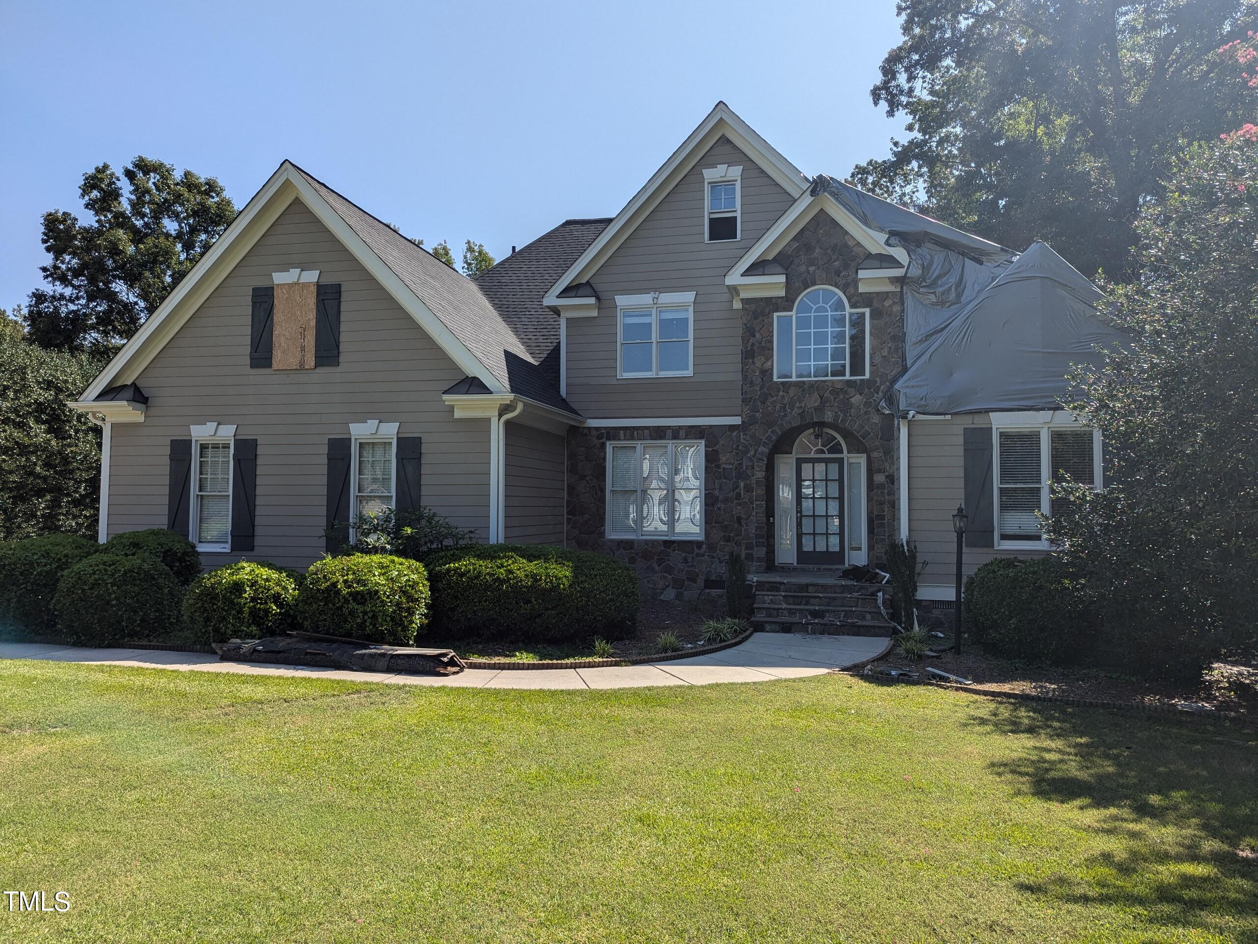 151 Michael Way Clayton, NC 27520 - Photo 9 of 36 a front view of a house with a yard and garage