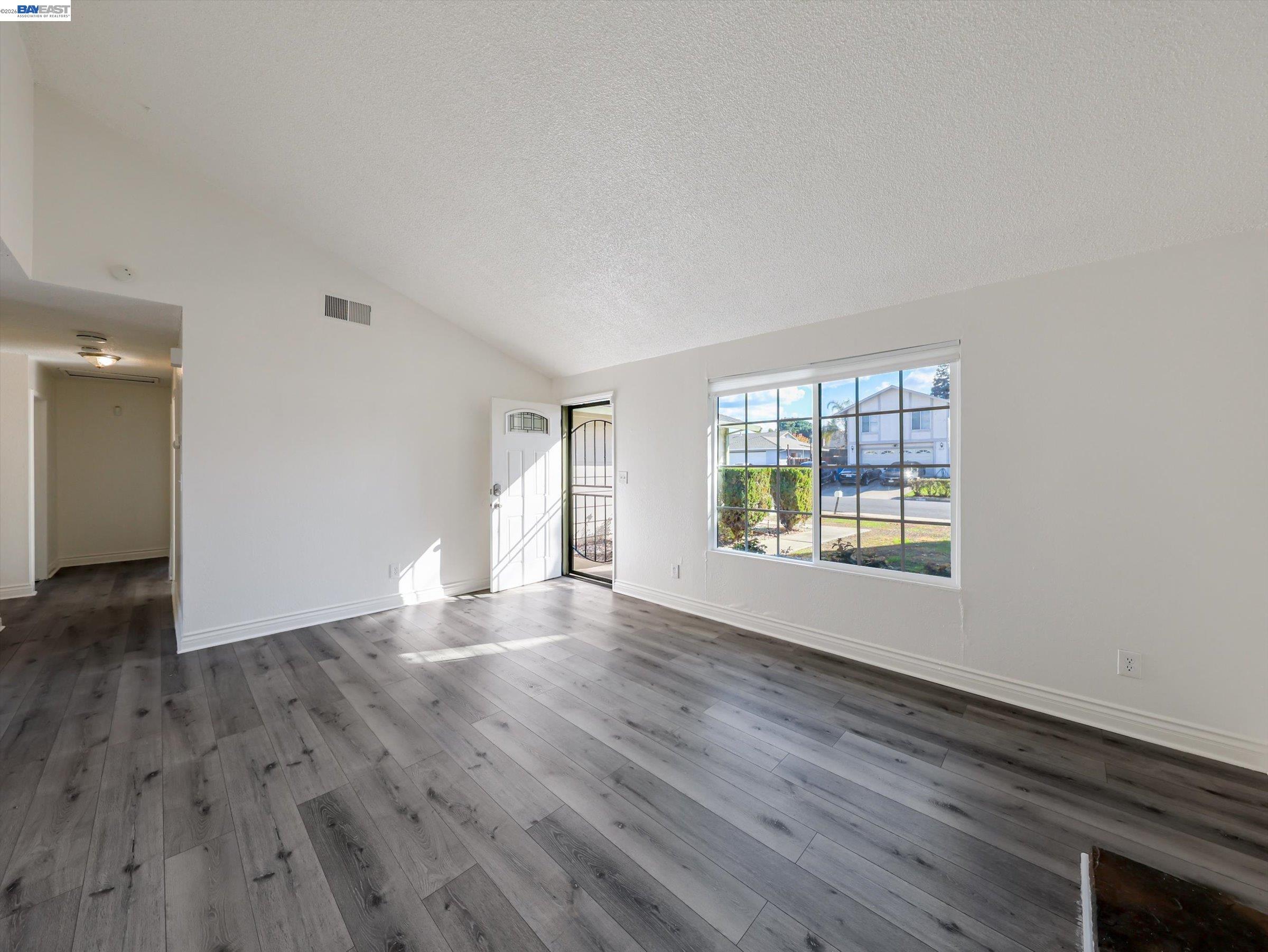 3432 Danielle Place Bay Point, CA 94565 - Photo 8 of 36 a view of an empty room with wooden floor and a window