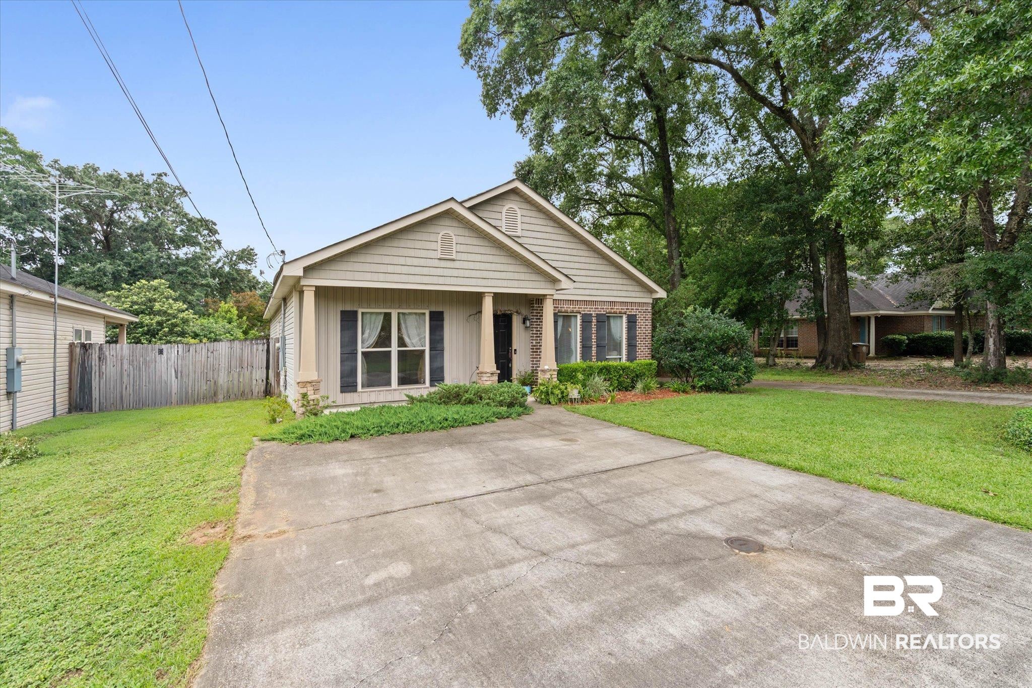 800 Galoway Avenue Mobile, AL 36609 - Photo 21 of 22 Single-story residence featuring siding and brick facade, a covered entry porch with pillars, and dark window shutters