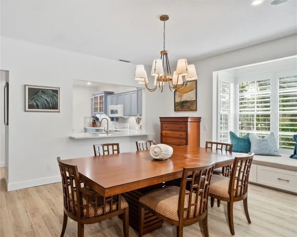 a view of a dining room with furniture wooden floor and chandelier