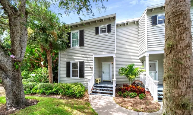 an aerial view of a house with a garden and trees