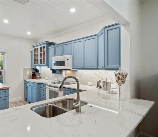 a kitchen with a sink cabinets and appliances