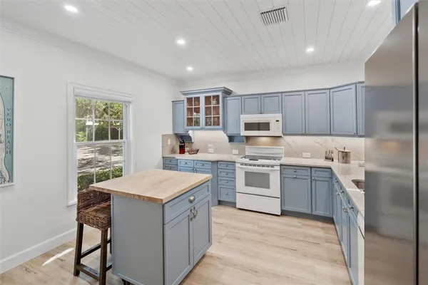a kitchen with a stove sink microwave and refrigerator