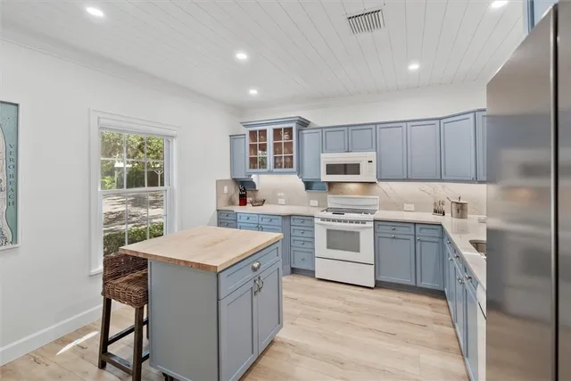 a kitchen with a stove sink microwave and refrigerator