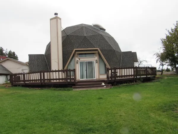 a view of a house with a yard and deck