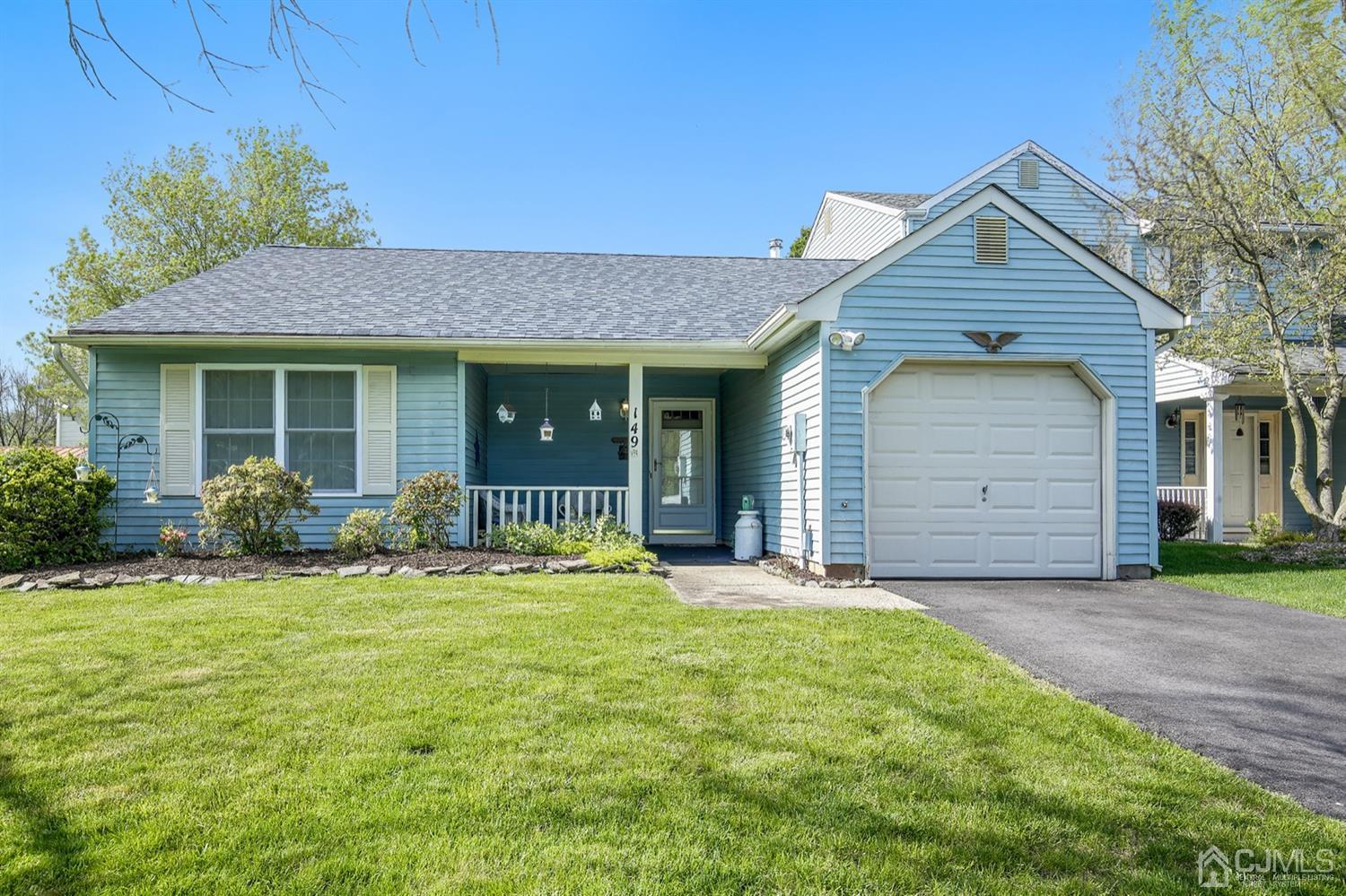 149 Woodbury Road Edison, NJ 08820 - Photo 1 of 19 a front view of a house with a garden and yard