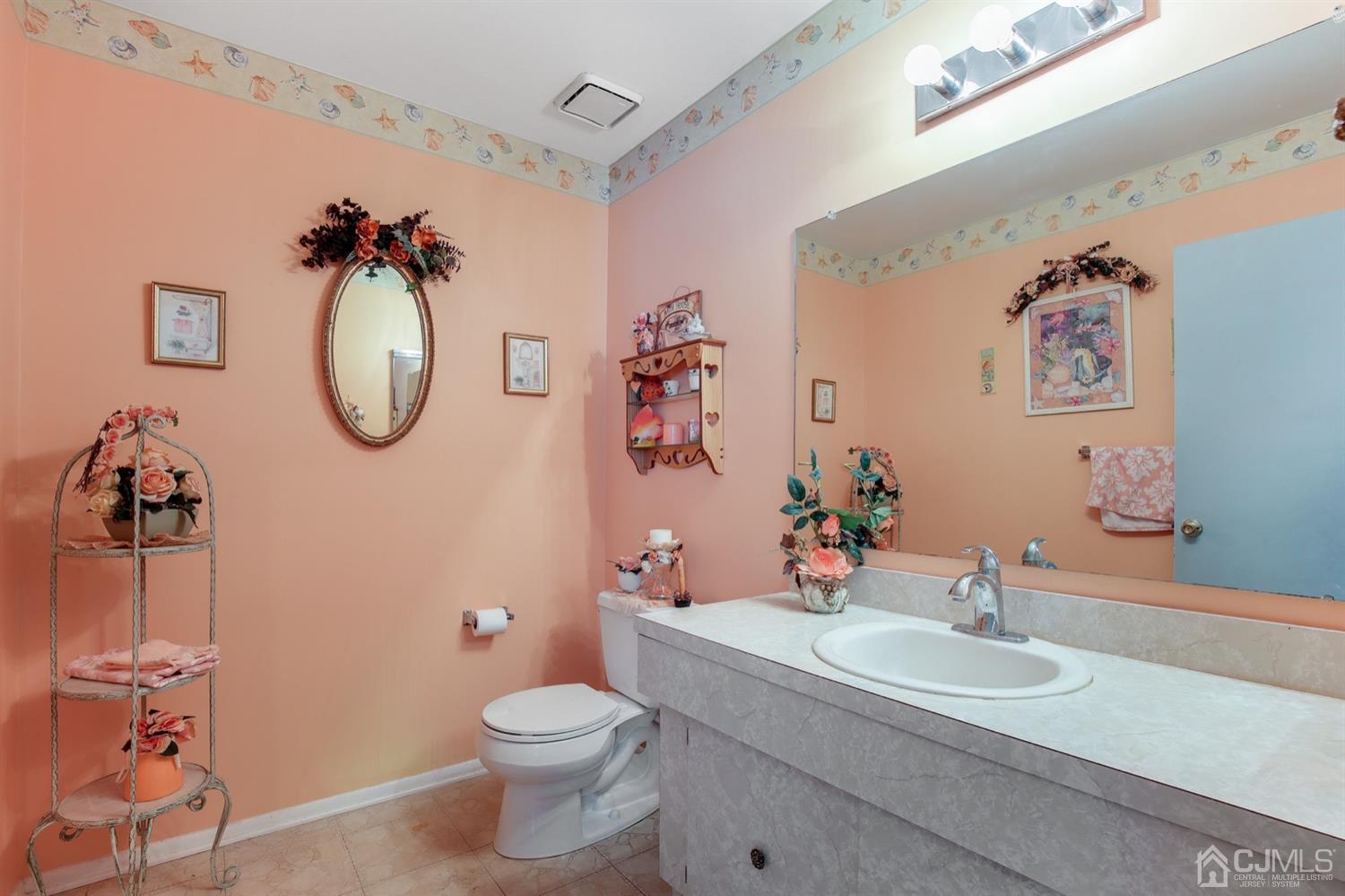 149 Woodbury Road Edison, NJ 08820 - Photo 14 of 19 a bathroom with a sink mirror and toilet