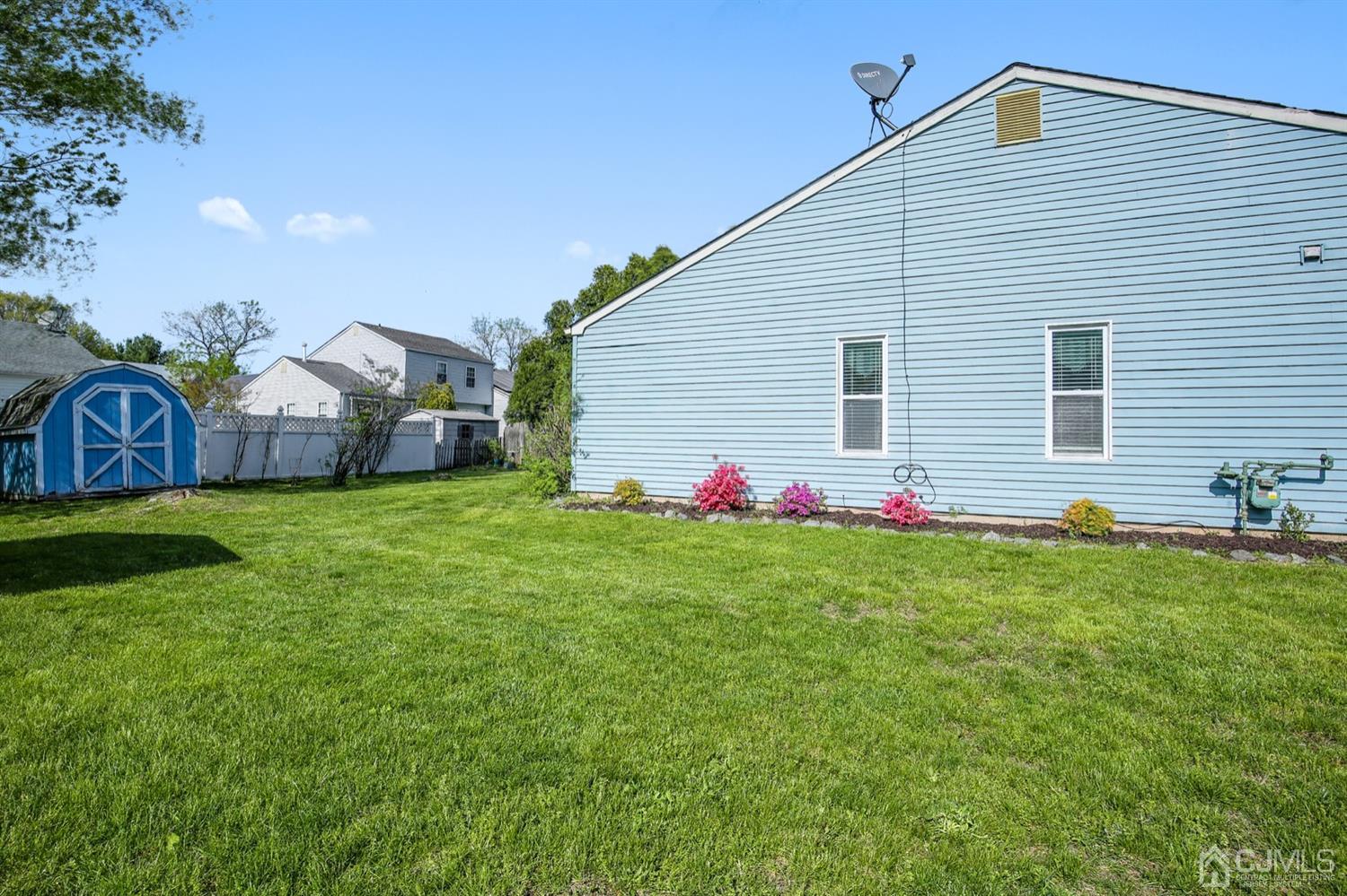149 Woodbury Road Edison, NJ 08820 - Photo 16 of 19 a front view of house with yard and seating area