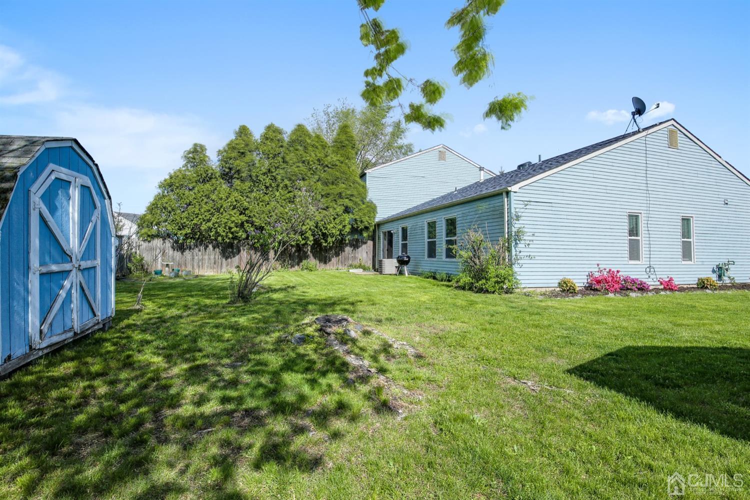 149 Woodbury Road Edison, NJ 08820 - Photo 18 of 19 a front view of house with yard and green space