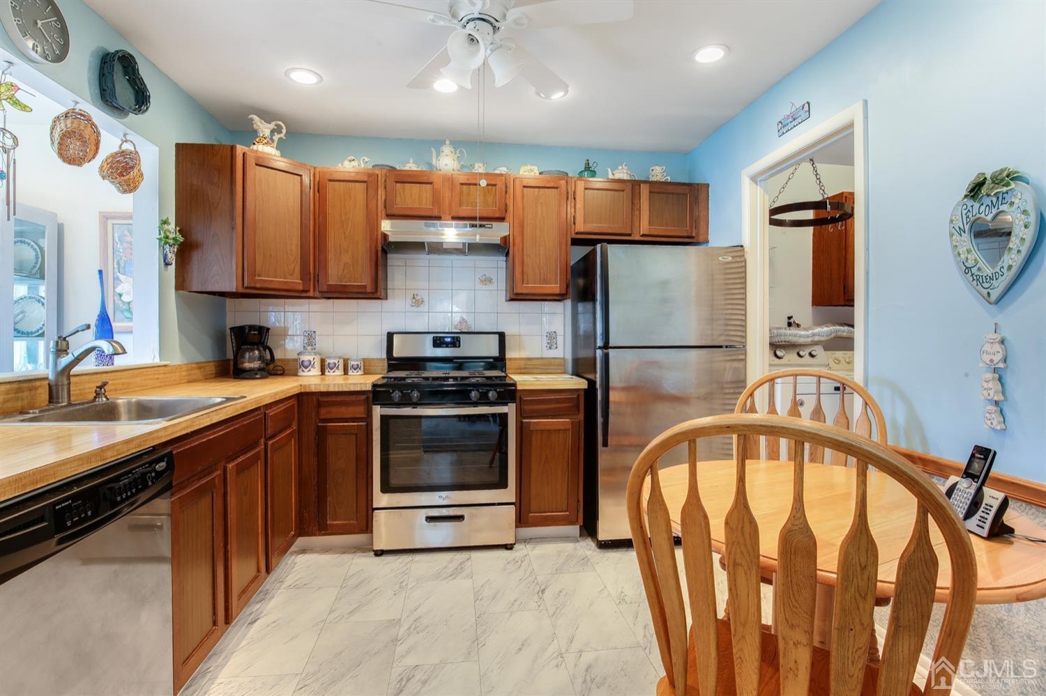 149 Woodbury Road Edison, NJ 08820 - Photo 9 of 19 a kitchen with stainless steel appliances granite countertop a refrigerator a stove top oven a sink and dishwasher