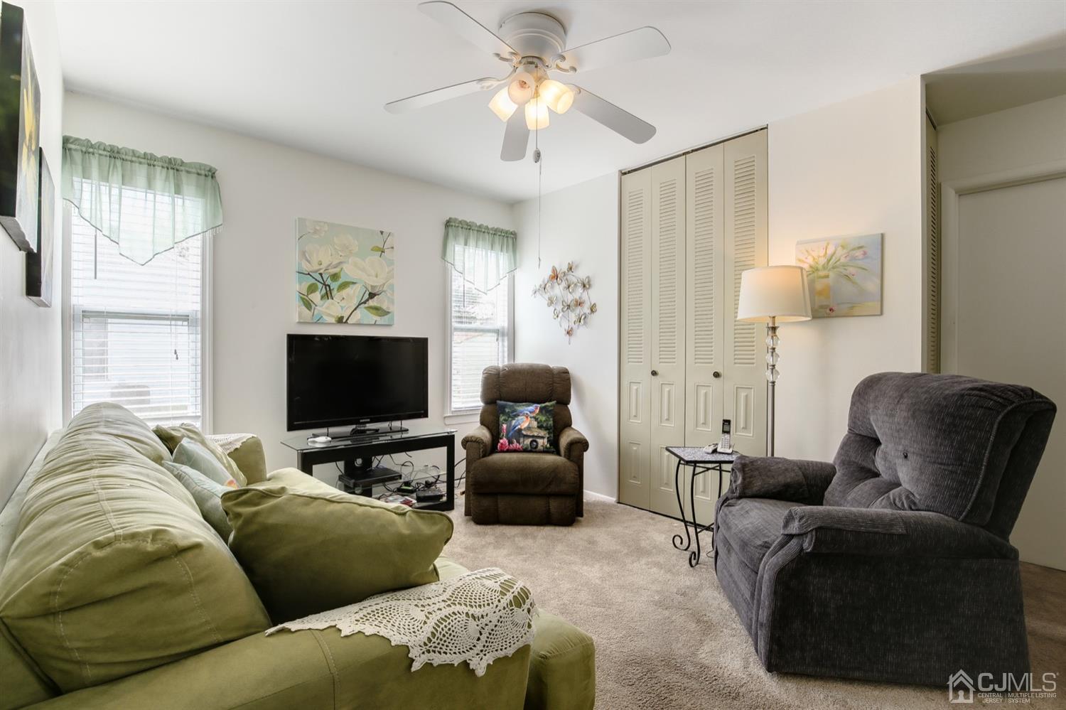149 Woodbury Road Edison, NJ 08820 - Photo 10 of 19 a living room with furniture and a flat screen tv