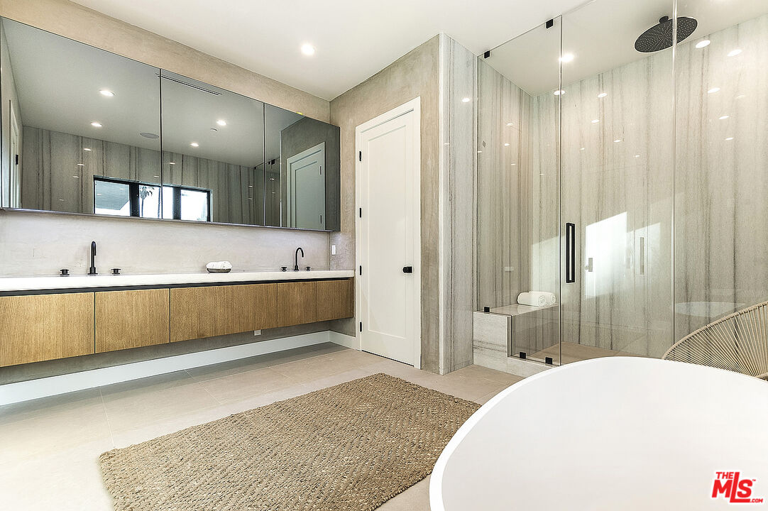 8566 Colgate Avenue Los Angeles, CA 90048 - Photo 13 of 22 a bathroom with a tub a sink and mirrors